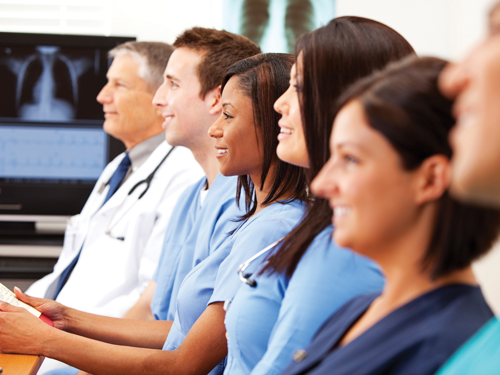 A group of healthcare professionals enjoy a classroom training session. 